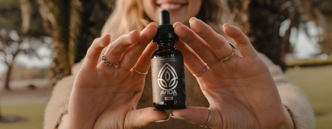 Woman Holding Vanilla CBD Oil