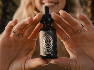 Woman Holding Vanilla CBD Oil