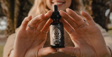 Woman Holding Vanilla CBD Oil